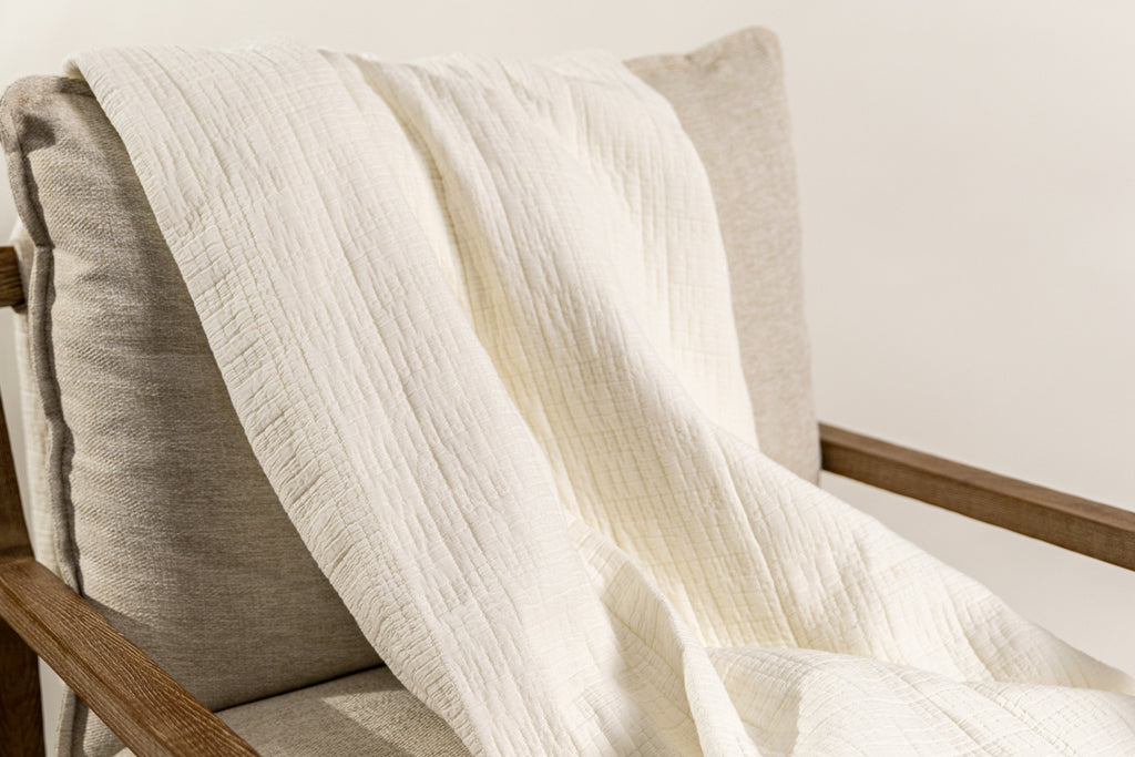 White blanket on chair on white background