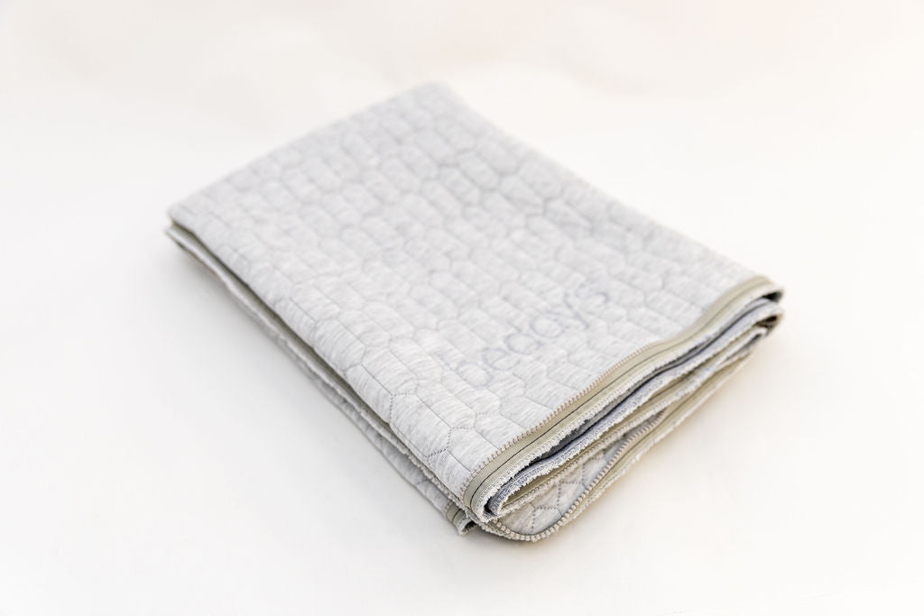 A replacement mattress top folded on a white background.