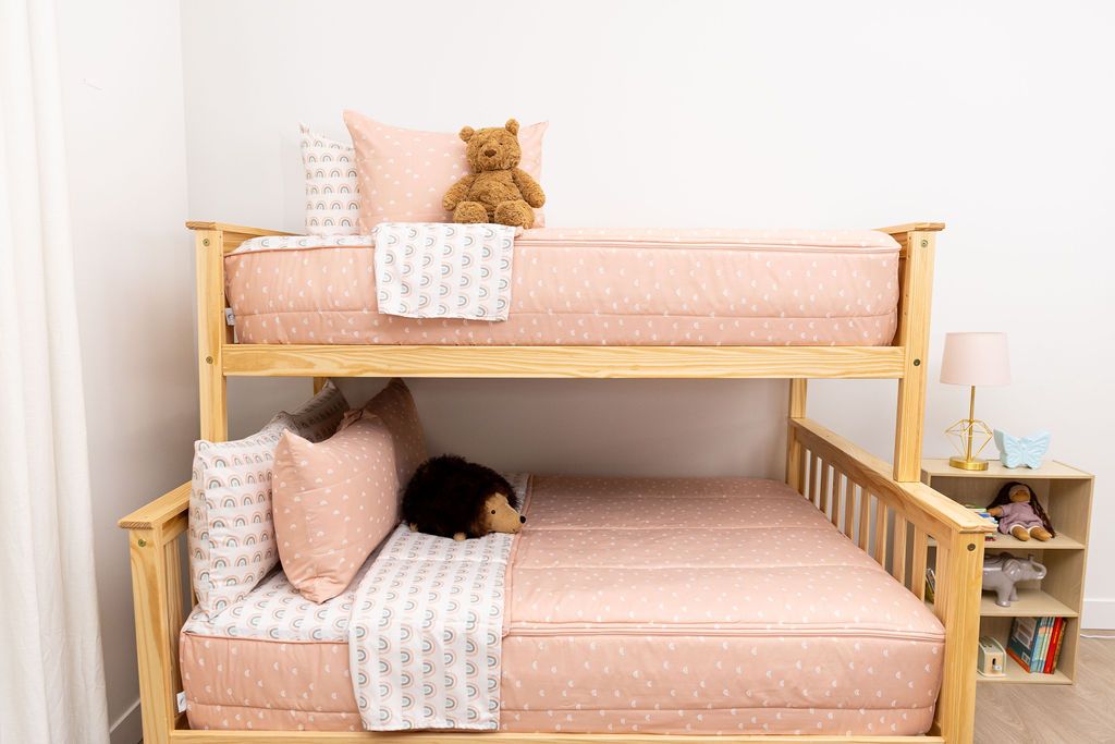 bedroom with bunk bed decorated with peachy pink rainbow printed  zipper bedding