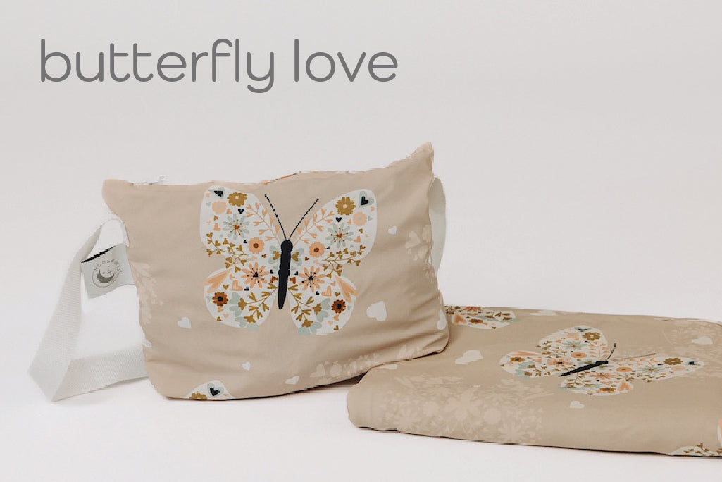 A child's butterfly print blanket and coordinating zipper pouch.