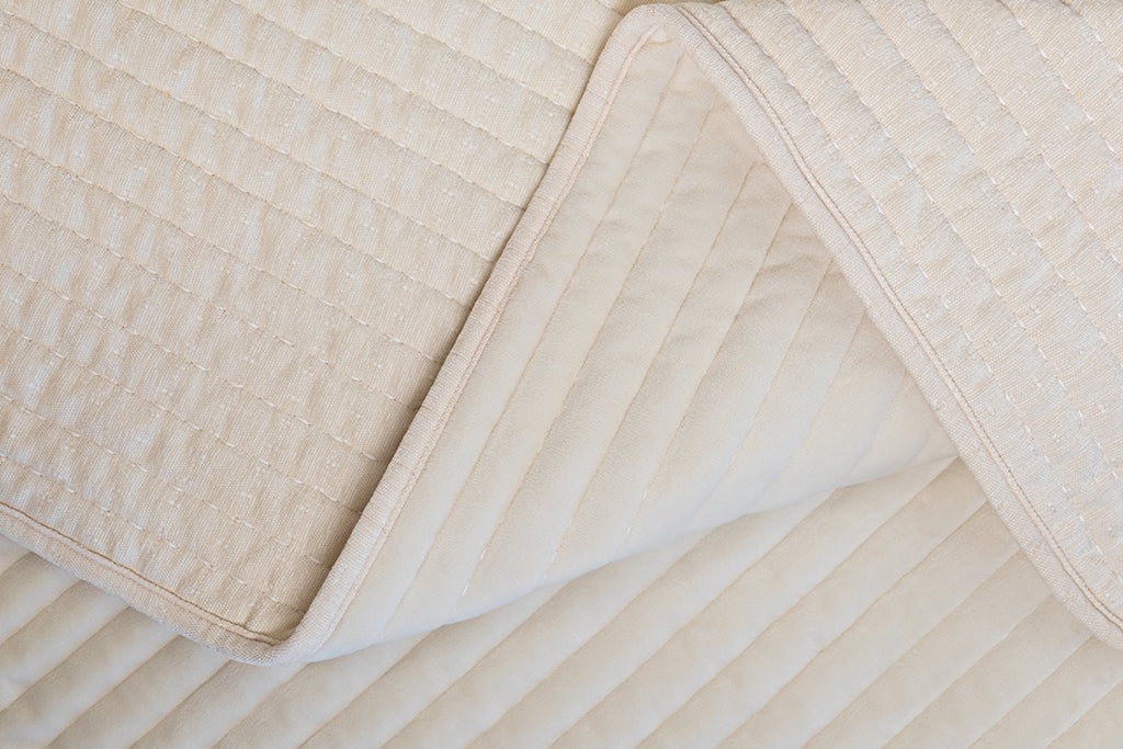 Photo with both textured and minky sides of cream blanket