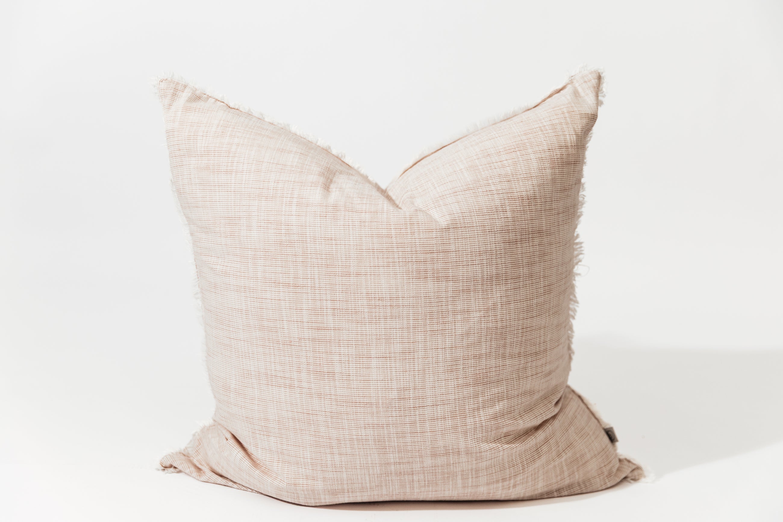 A light pink woven striped euro pillow arranged on a white background.