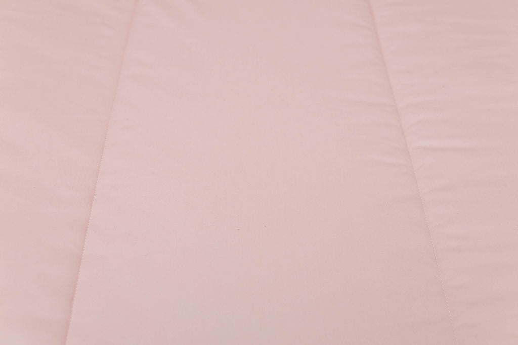A close up detailed exterior view of a pink zipper bedding.