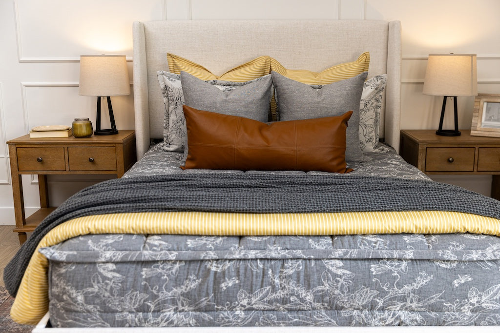 A cream sketched floral pattern with a charcoal base zipper bedding with gray, yellow and rustic accessories.