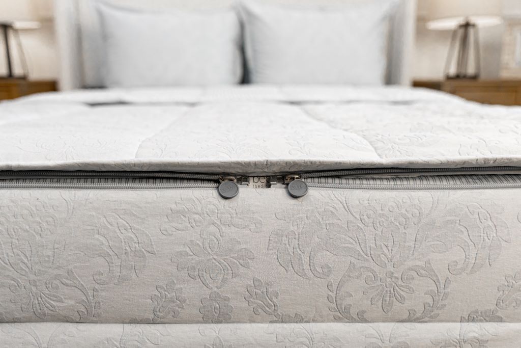 End of bed showing double zippers on blue floral zipper bedding