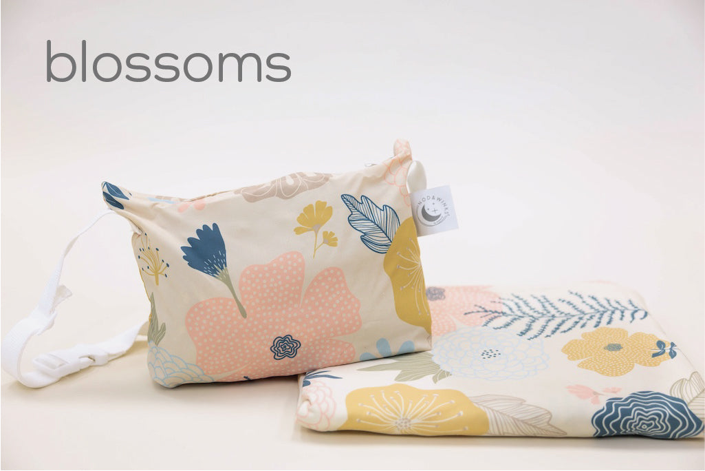 A child's floral print blanket and coordinating zipper pouch