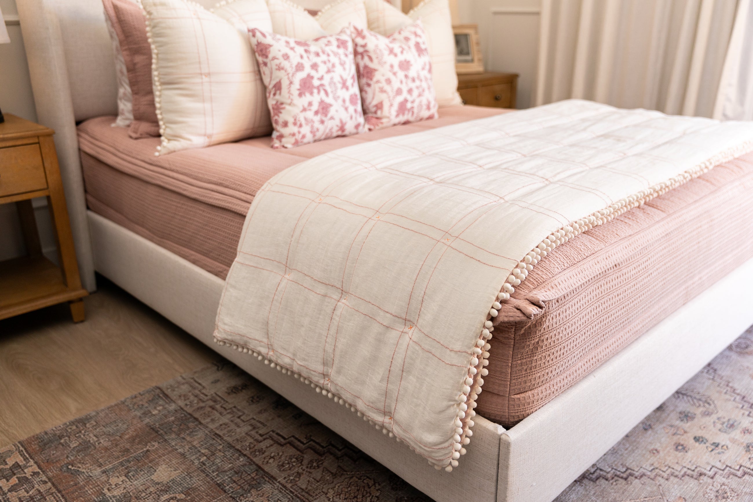 Pink bedding with white and pink pillows and blanket