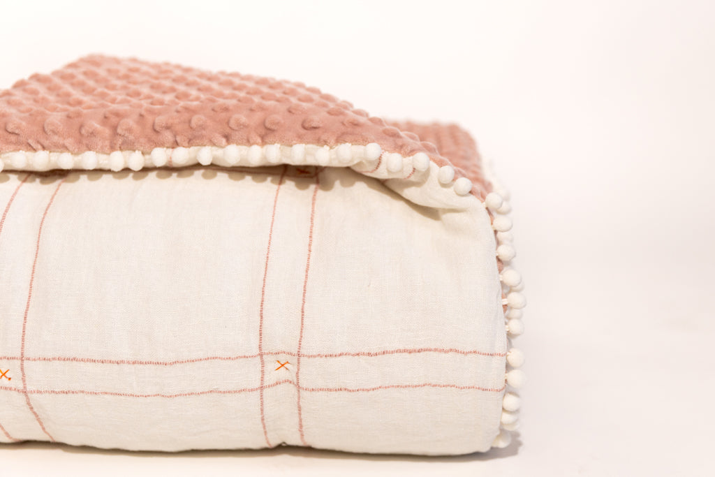 White background photo of white and pink blanket