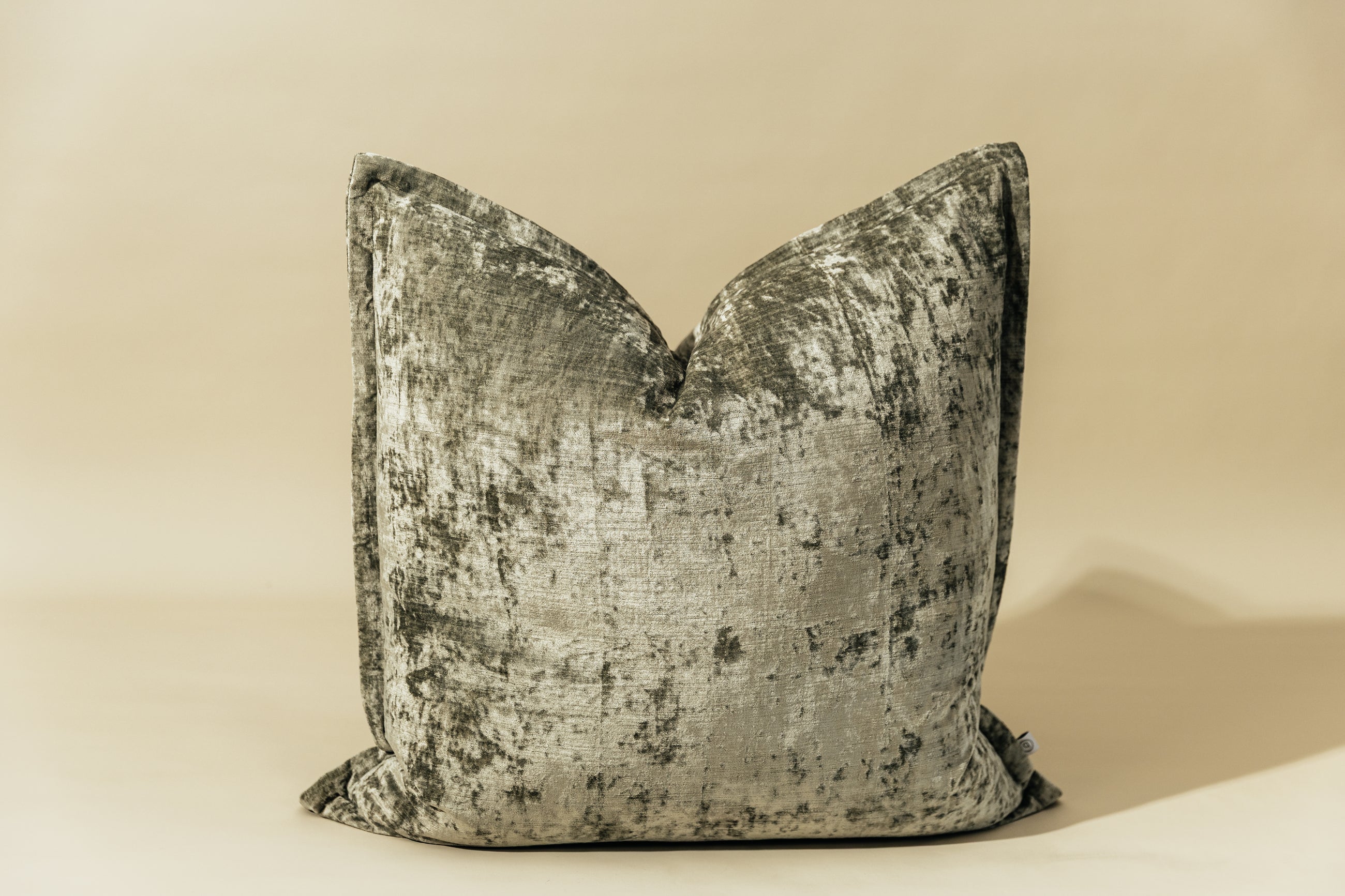 A sage velvet green XL euro pillow arranged on a light green background.