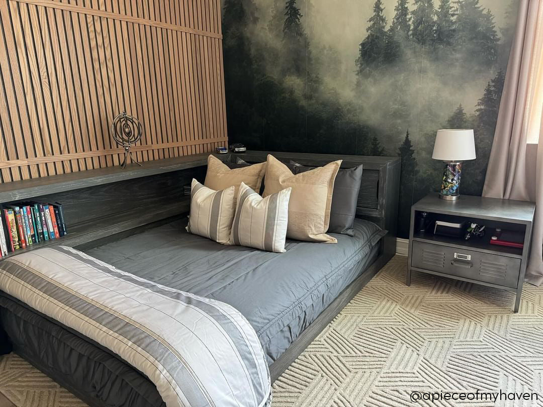 A floor bed made with gray zipper bedding and neutral and gray striped pillows and blanket.