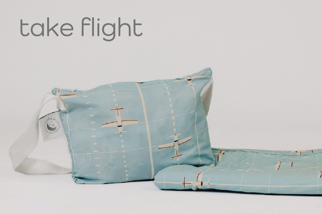 A child's airplane print blanket and coordinating zipper pouch.