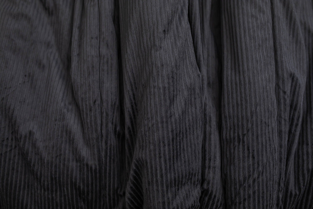 A close up view of a black minky blanket.