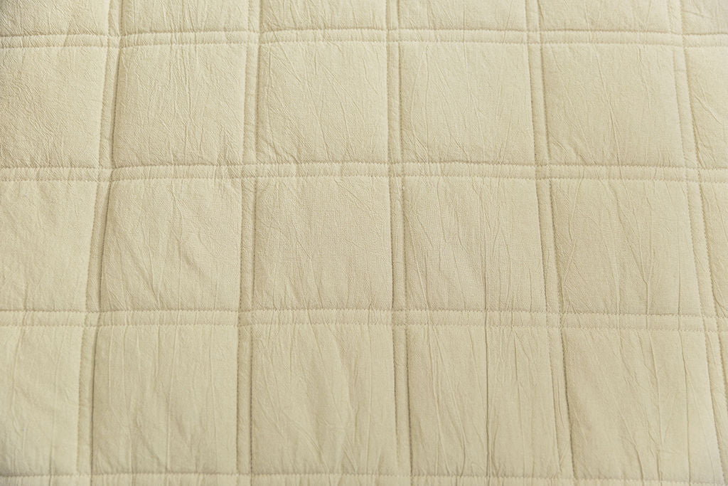 A close up detailed view of a khaki green zipper bedding exterior.