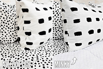 side by side comparison photo of white bedding with black dashed lines with white and black polka dot sheets one side showing white minky interior, the other showing cotton interior