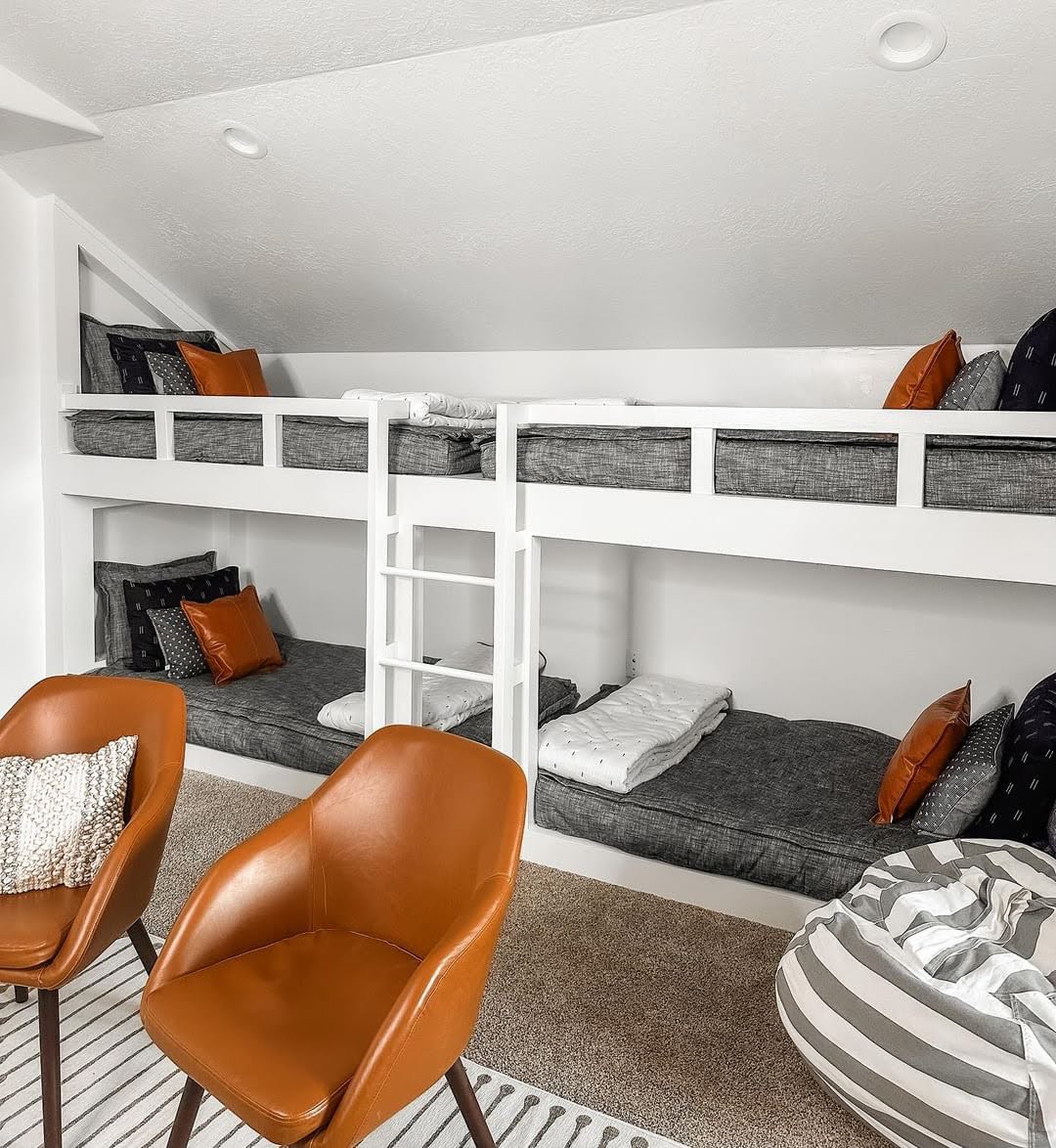 
      bunk beds with gray sheets and pillows in a child's bedroom
    