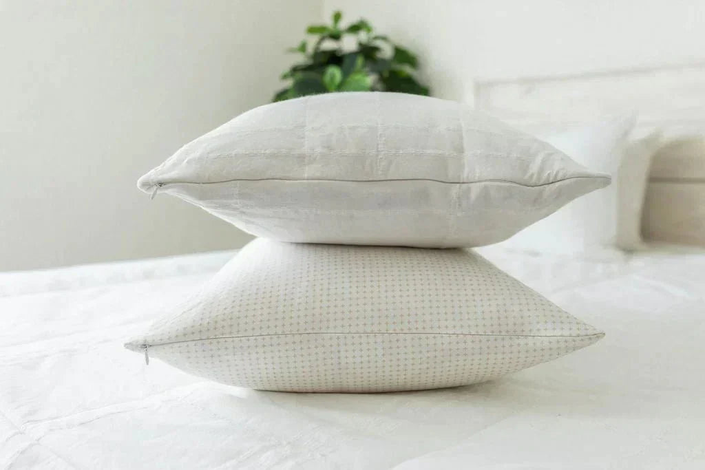 
      A side view of a bed made with zipper bedding with two pillows stacked on top.
    