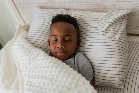 
      Young boy sleeping in a cream textured unzipped zipper bedding.
    