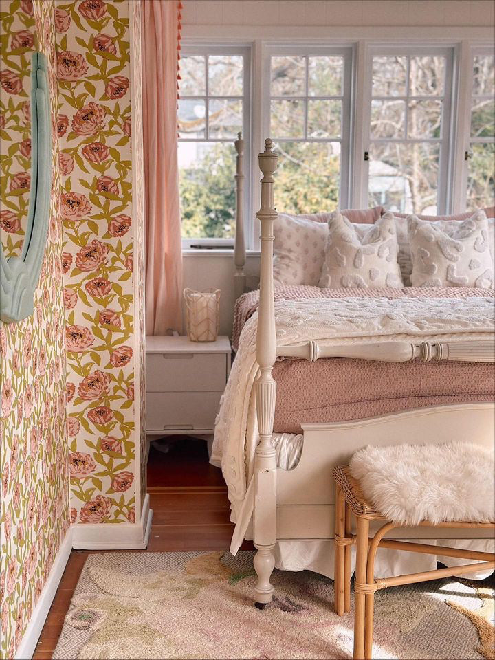 
      A girls room with floral wallpaper and a four poster bed made with dusty pink zipper bedding.
    
