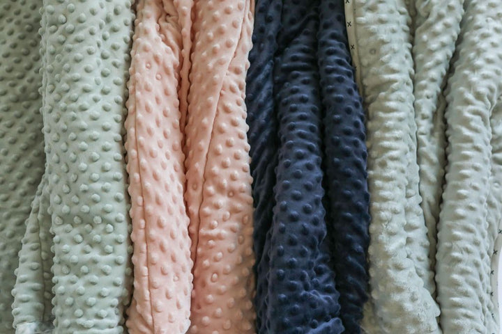Assortment of mini blankets with different color minky interiors 