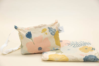 A child's floral print blanket and coordinating zipper pouch