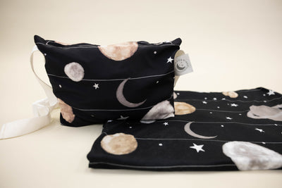 A child's space print blanket and coordinating zipper pouch