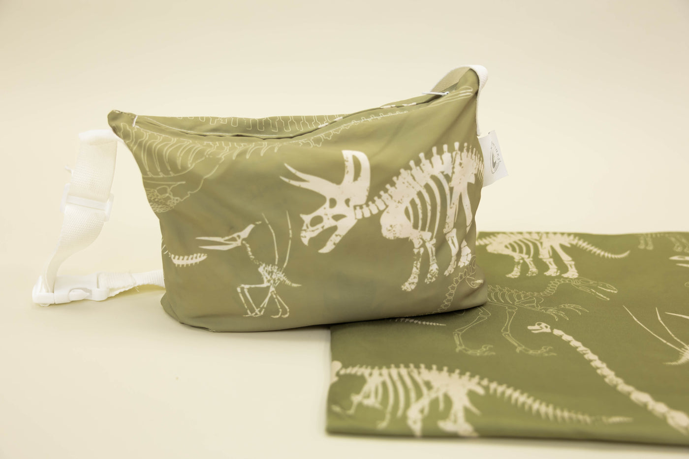 A child's dino print blanket and coordinating zipper pouch