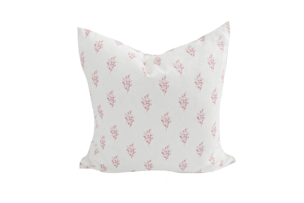white pillow with pink floral pattern