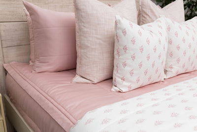 Pink zipper bedding bundle with coordinating floral pillows and floral blanket