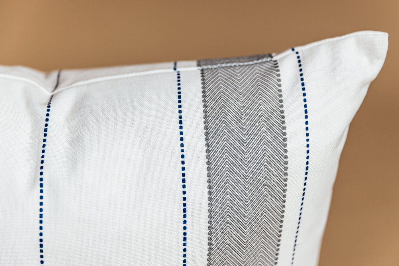 A close up of the striped detailing on the exterior of the Ethan pillow.