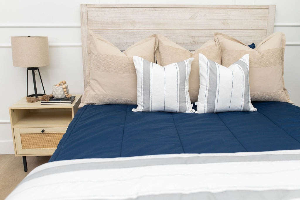 Navy blue zipper bedding with neutral pillows
