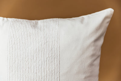 A close up on a white throw pillow to show the detailed texture on the exterior.