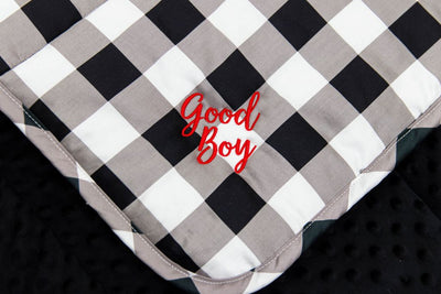 white, black and gray child's blanket with red embroidery