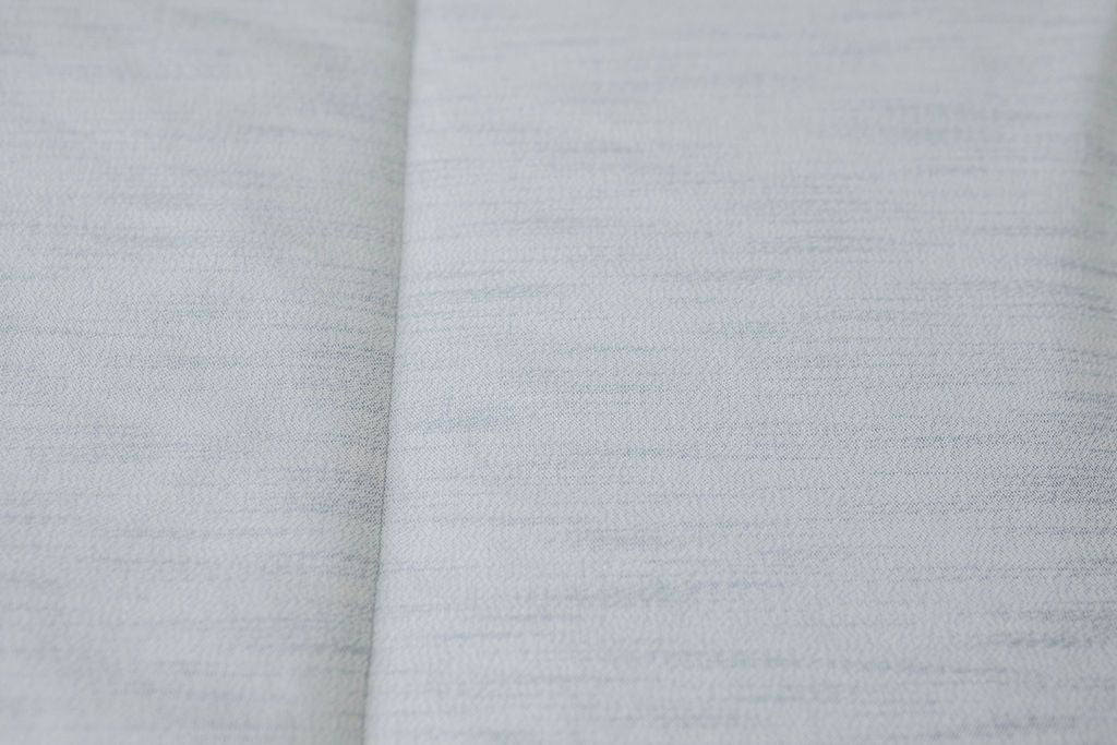 Close up of light blue zipper bedding
