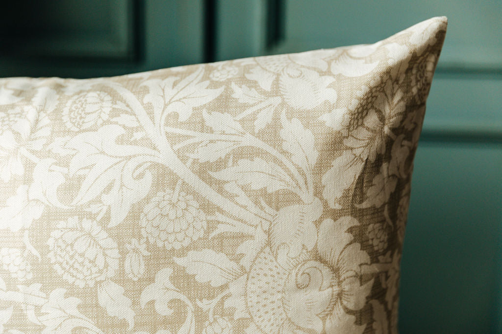 A close up on a floral lumbar pillow to show the floral print on the exterior.