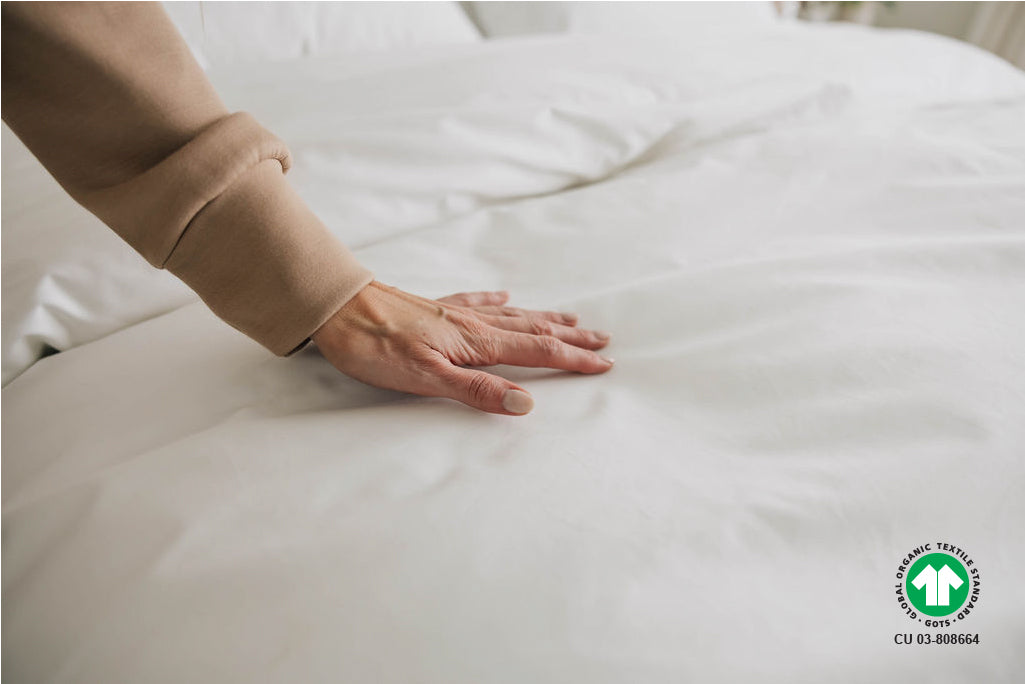 woman touching organic duvet cover