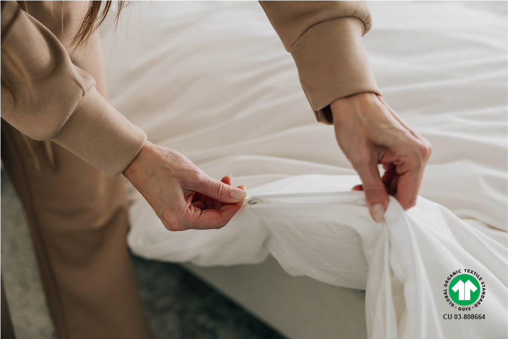 woman zipping organic duvet 