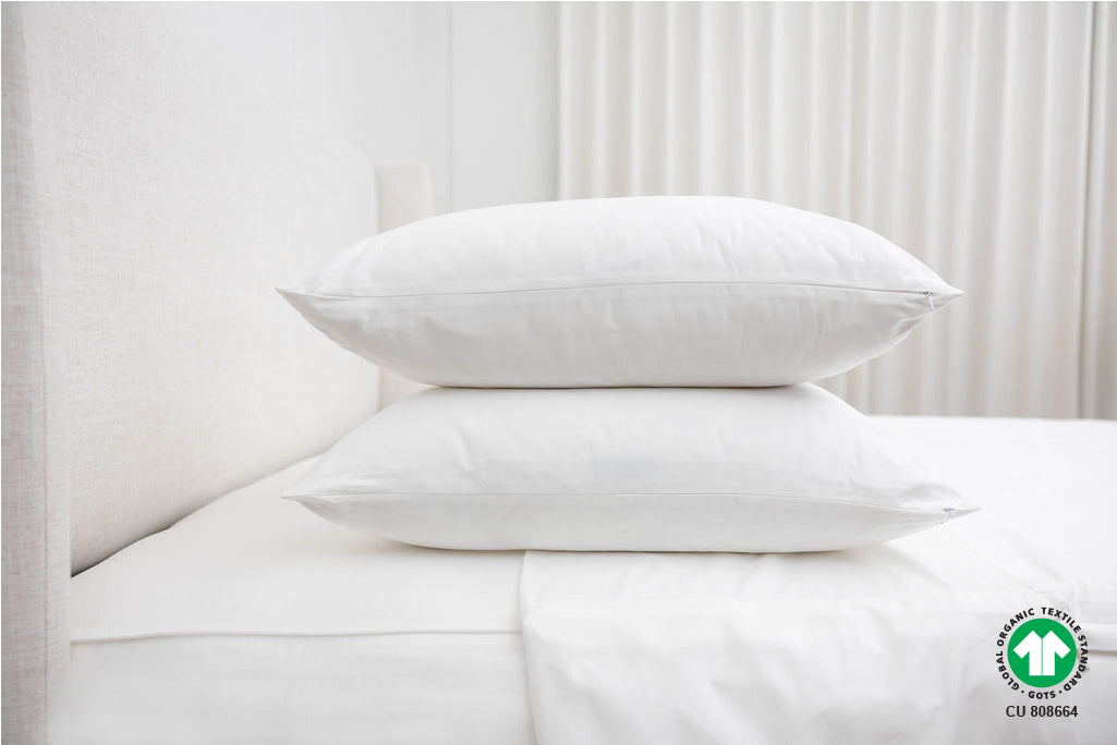 two pillows stacked on top of organic zipper sheets