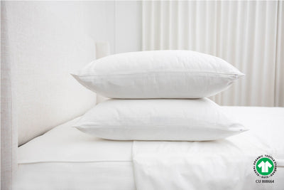 two pillows stacked on top of organic zipper sheets