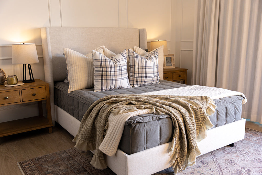 Classic gray zipper bedding with cream, tan, and plaid accessories.