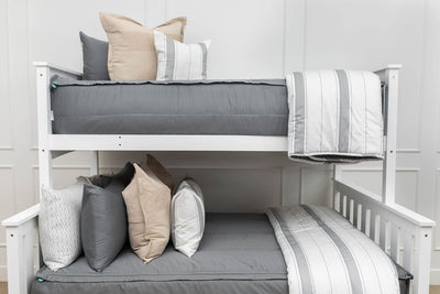 Gray zipper bunk bed bedding with neutral pillows and blankets
