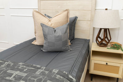 Gray zipper bedding with tan and gray accessories