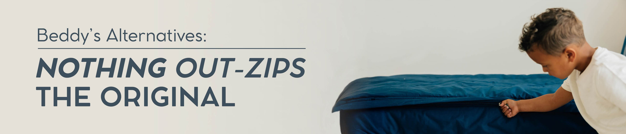 A young boy zipping up a set of blue zipper bedding.