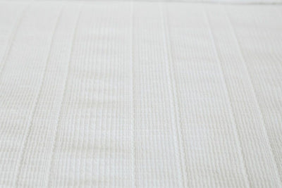 Close up showing texture of white duvet bedding