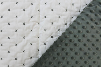 Creamy white blanket exterior with green "x" stitching and green minky interior