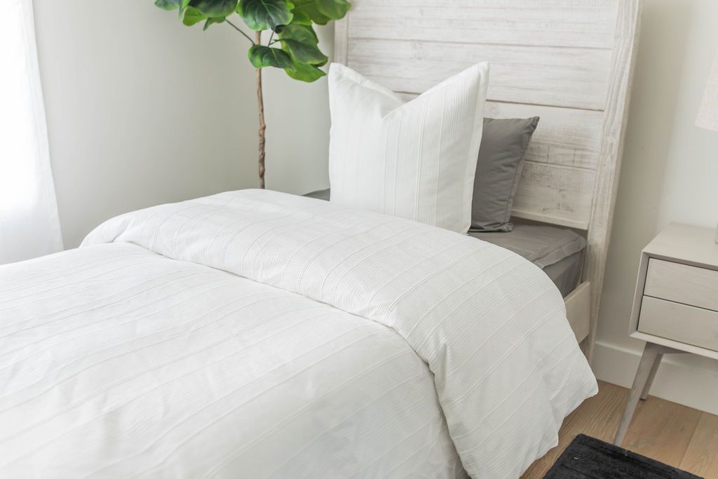 White duvet bedding with matching white pillows on bed