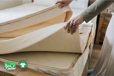 woman holding different layers inside organic mattress