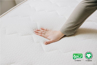 woman pushing on organic mattress