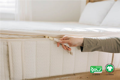 Woman puling zipper on organic mattress