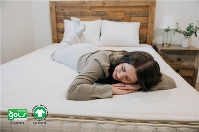 Woman laying on stomach across organic mattress