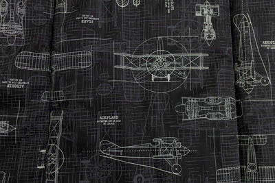 An airplane design charcoal gray print blanket close up view.